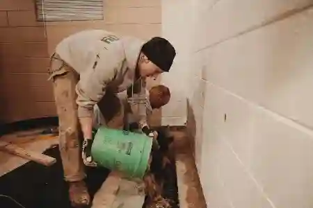 McCoy Contractors filling drain tile during basement waterproofing repair Milwaukee