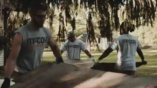 McCoy Contractors foundation repair team carrying boards Milwaukee