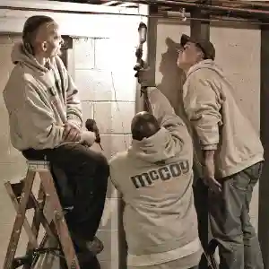 McCoy Contractors foundation repair crew inspecting basement issues Milwaukee