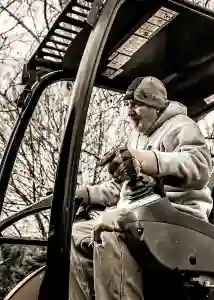 McCoy Contractors foreman in driver's seat of lift during foundation repair Milwaukee