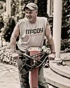 McCoy Contractors foreman with jackhammer smiling - foundation repair professional Milwaukee