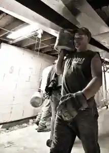 McCoy Contractors foundation repair crew working in basement moving concrete Milwaukee