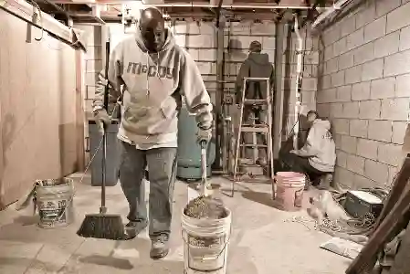 McCoy Contractors foundation repair crew working in basement cleanup Milwaukee