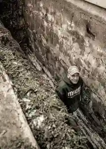 McCoy Contractors foundation repair crew working in hole along block wall Milwaukee